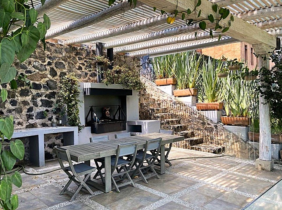 Espacio exterior con asador y áreas de estar